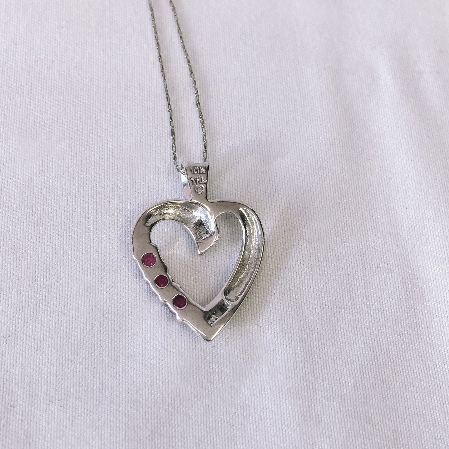 10k White Gold THL Open Heart Pendant Necklace with Ruby and Diamond Chip