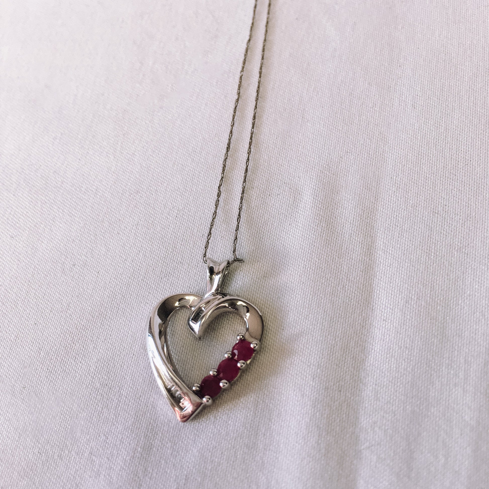 10k White Gold THL Open Heart Pendant Necklace with Ruby and Diamond Chip