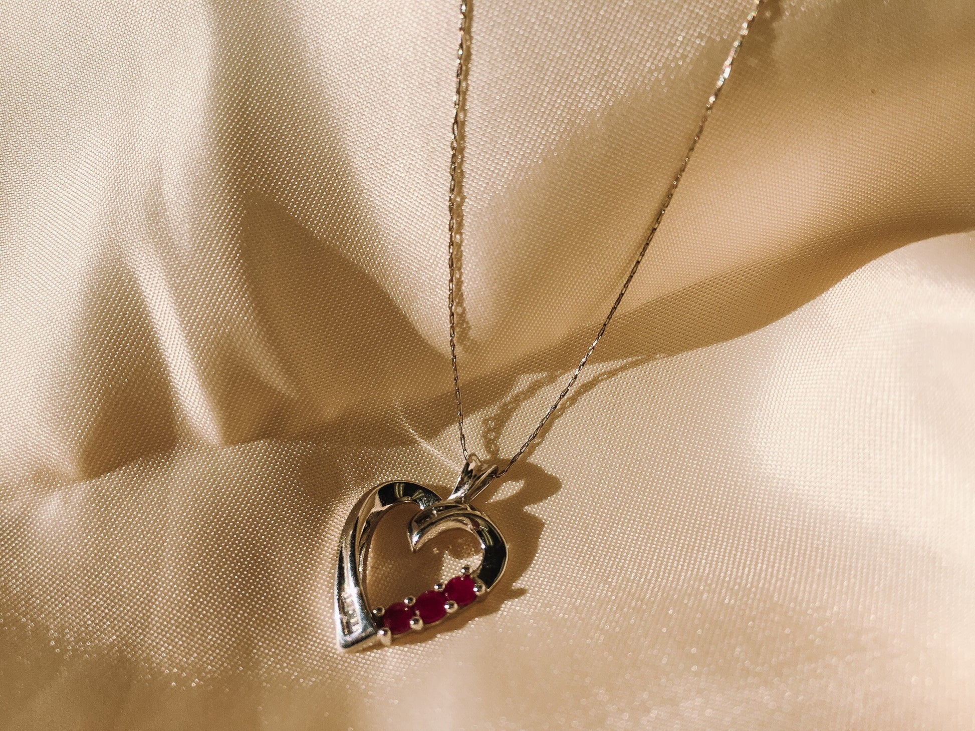 10k White Gold THL Open Heart Pendant Necklace with Ruby and Diamond Chip